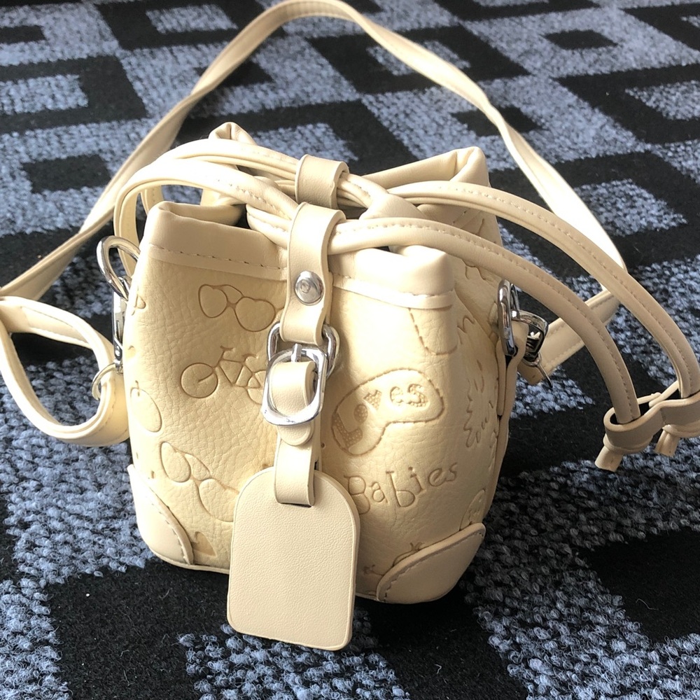 Cream Embossed Crossbody Bag with Playful Motif